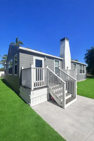 a view of backyard with deck and garden