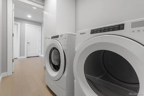 a living room with furniture a chandelier and a dining table