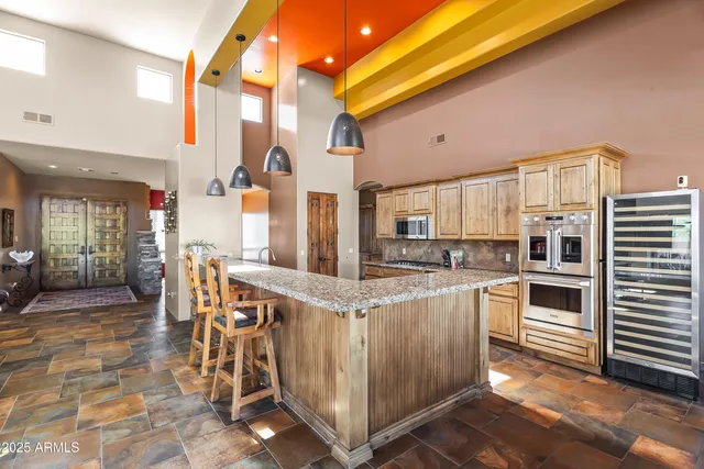 a open kitchen with stainless steel appliances granite countertop a stove and cabinets