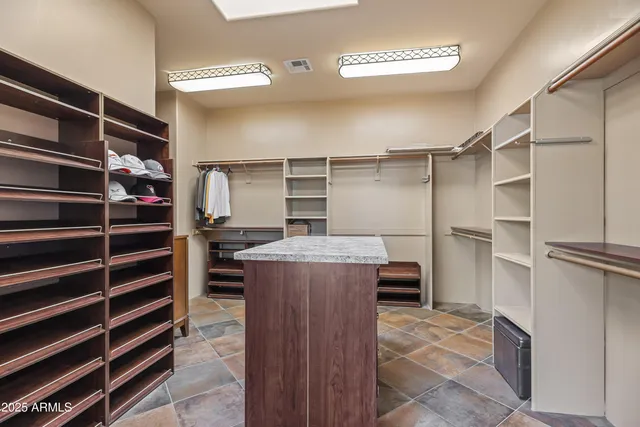 a view of walk in closet with empty racks