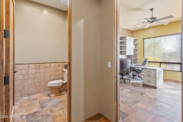 a bathroom with a toilet sink and shower