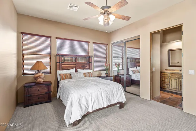 a bedroom with a large bed and a chandelier