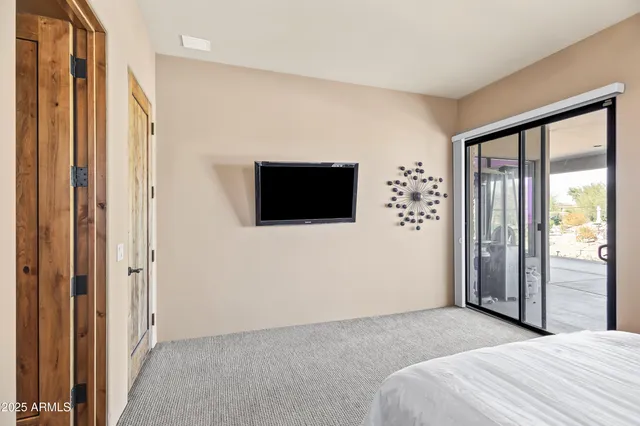 a bedroom with a bed and a flat screen tv