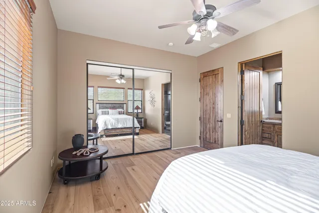 a bedroom with a bed and a large window