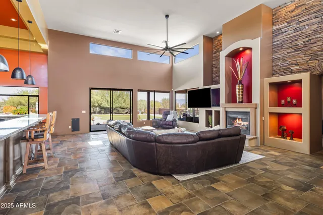 a living room with fireplace furniture and a flat screen tv