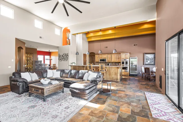 a living room with patio furniture and a table