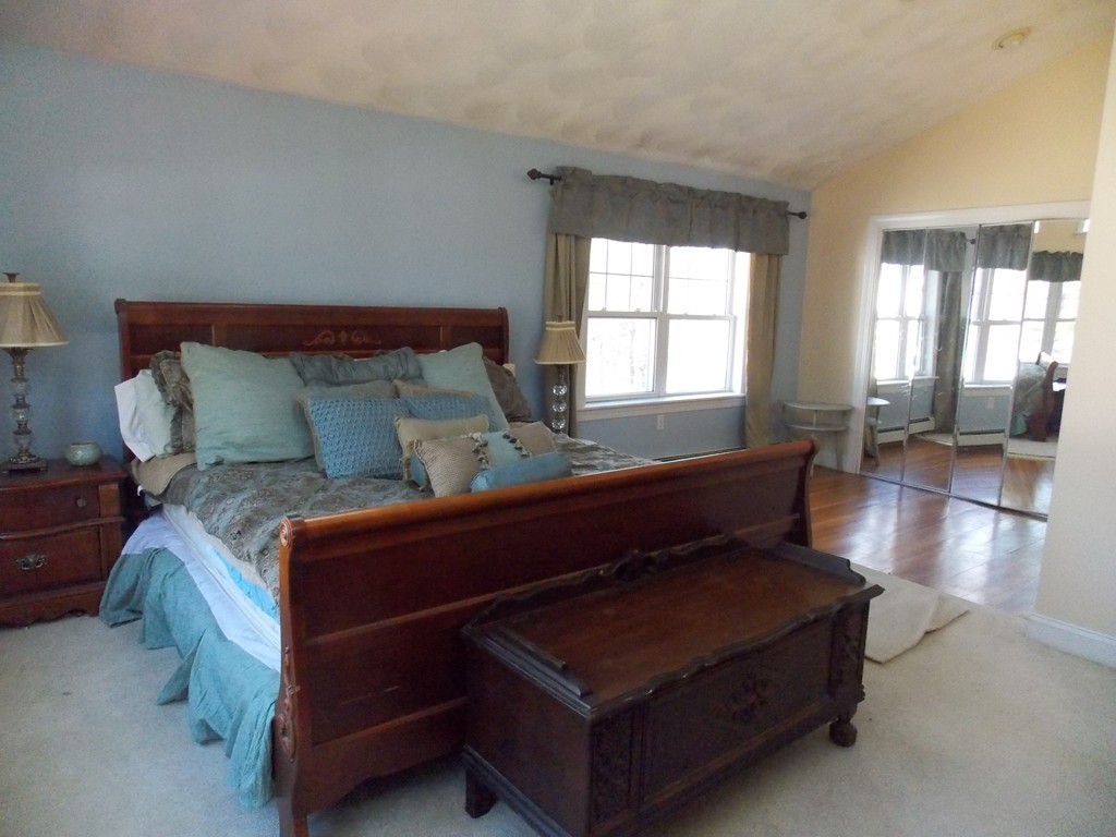 79 Haverhill Road Amesbury, MA 01913 - Photo 18 of 25 a bed sitting in a bedroom next to a window