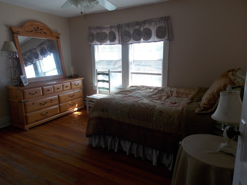 79 Haverhill Road Amesbury, MA 01913 - Photo 21 of 25 a bedroom with a bed a dresser with wooden floor