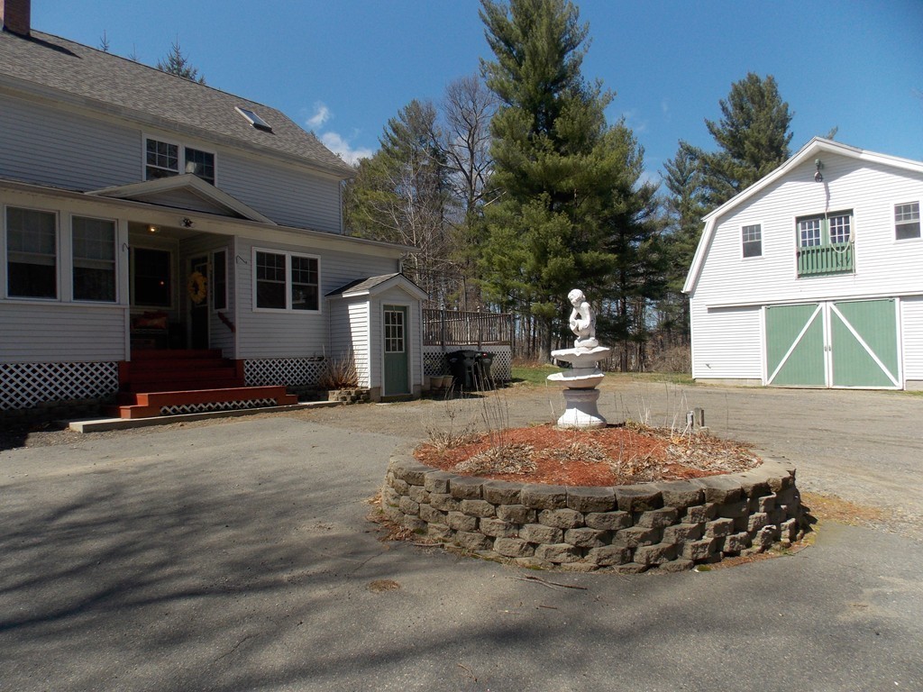 79 Haverhill Road Amesbury, MA 01913 - Photo 23 of 25 a front view of a house with a yard