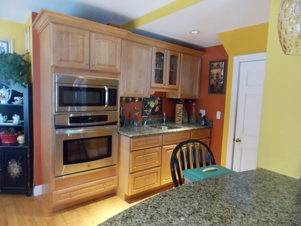 79 Haverhill Road Amesbury, MA 01913 - Photo 3 of 25 a kitchen with stainless steel appliances granite countertop a refrigerator and a stove top oven