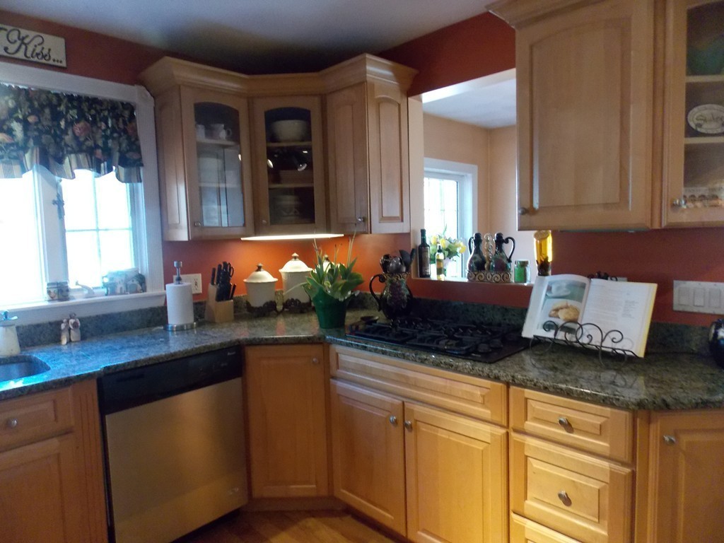 79 Haverhill Road Amesbury, MA 01913 - Photo 5 of 25 a kitchen with granite countertop a sink and a white wooden cabinets
