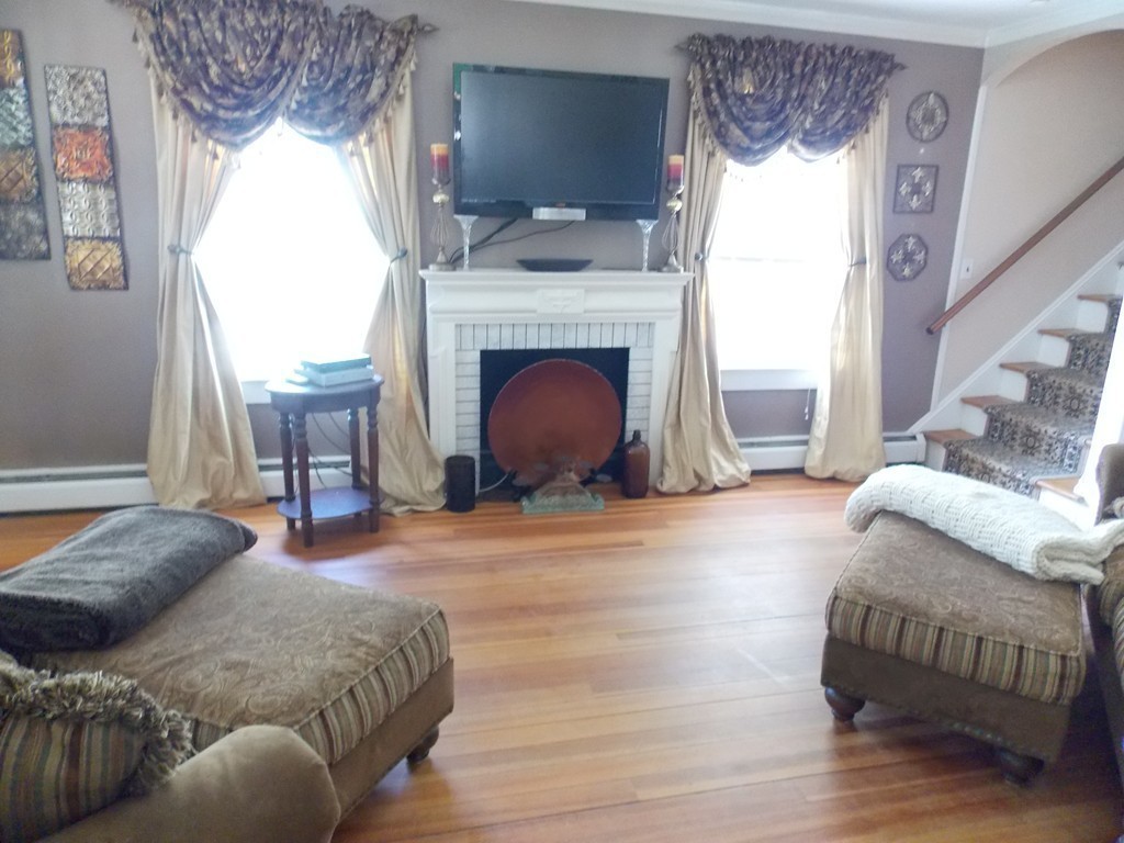 79 Haverhill Road Amesbury, MA 01913 - Photo 9 of 25 a living room with furniture and a fireplace