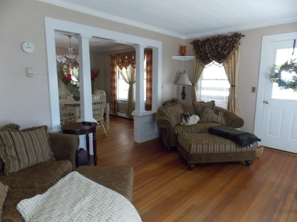 79 Haverhill Road Amesbury, MA 01913 - Photo 10 of 25 a living room with furniture and a large mirror next to a window