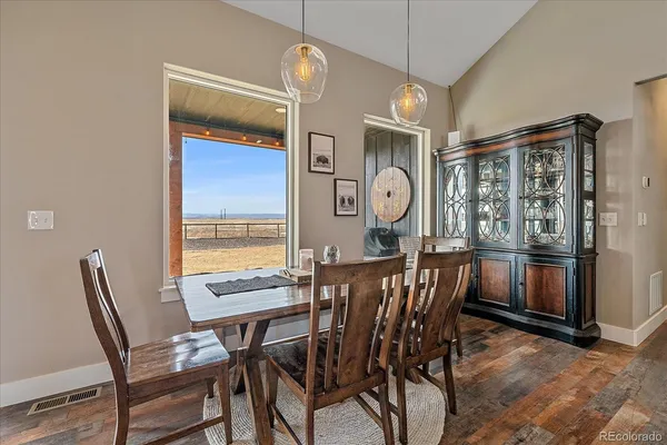 a view of a dining room with furniture and window