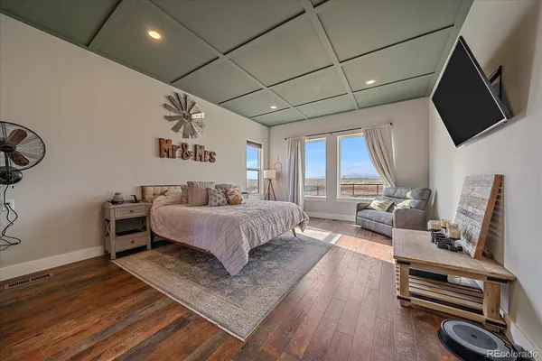 a bedroom with bed and flat screen tv