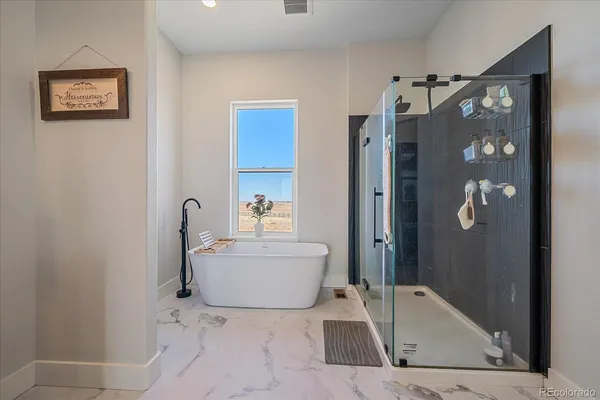 a bathroom with a tub and shower