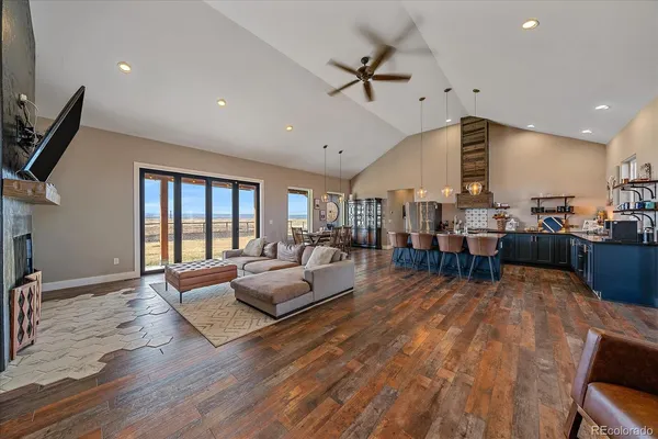 a living room with lots of furniture and kitchen view