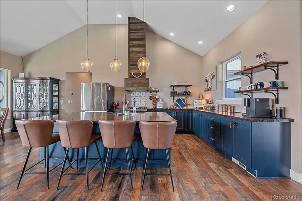 a large kitchen with a table and chairs