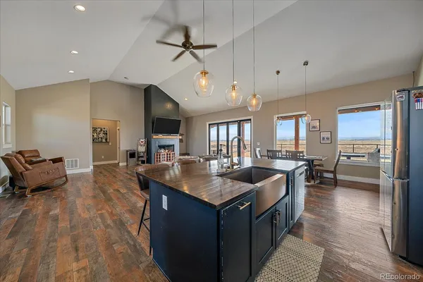 a kitchen with granite countertop a sink counter top space and stainless steel appliances