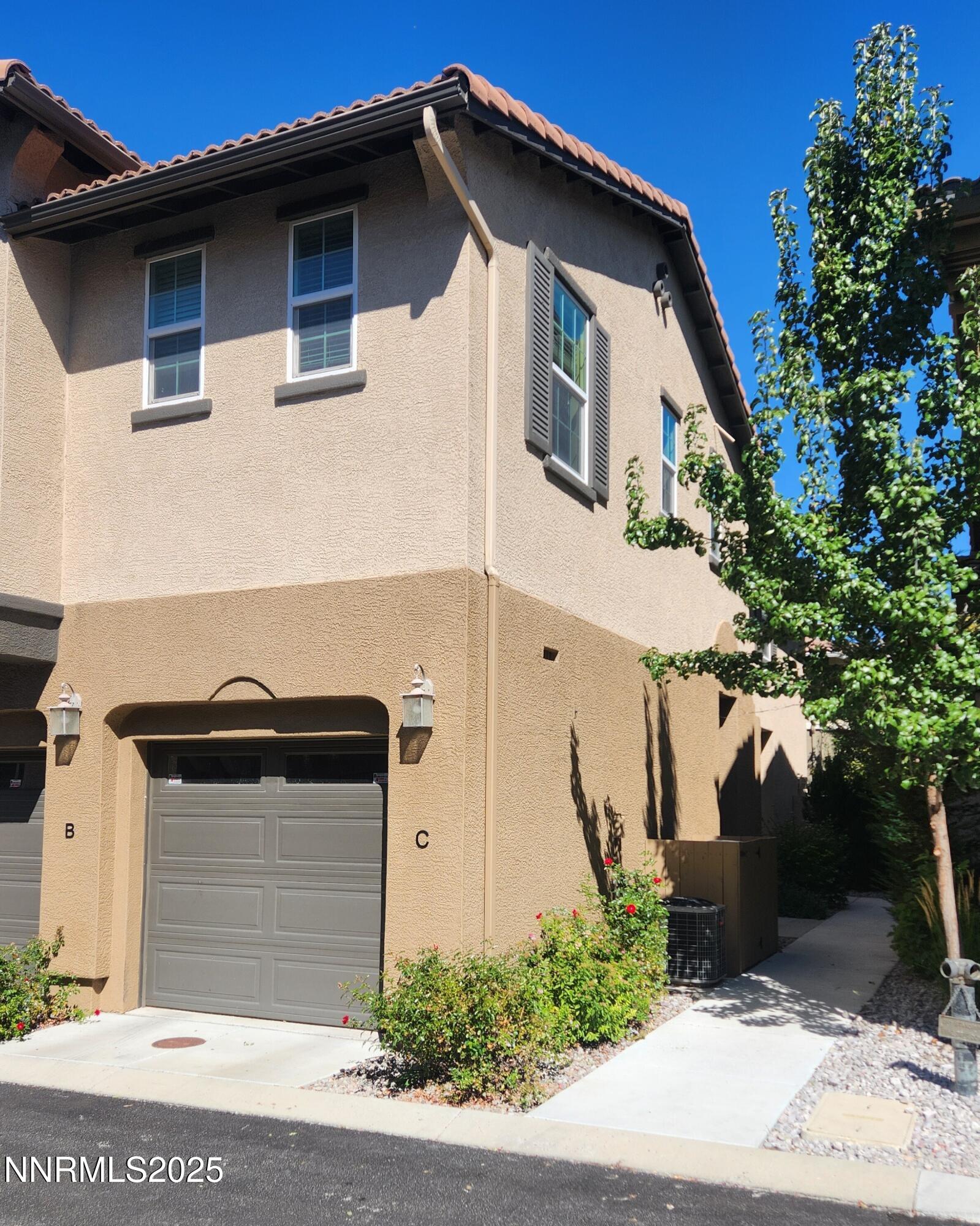1828 Wind Ranch Road, Unit C Reno, NV 89521 - Photo 2 of 6 a front view of a house with plants