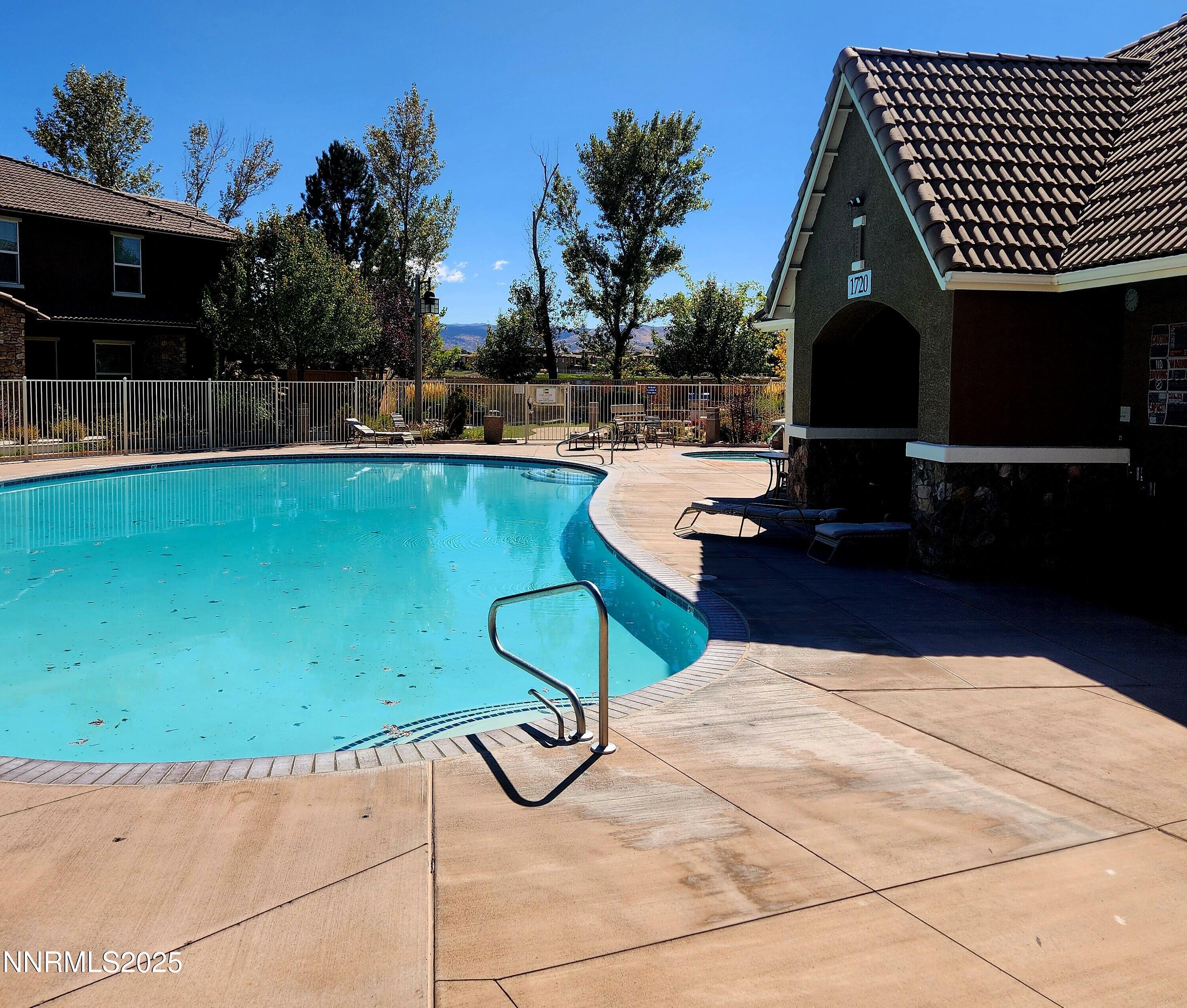 1828 Wind Ranch Road, Unit C Reno, NV 89521 - Photo 3 of 6 a backyard of a house with table and chairs