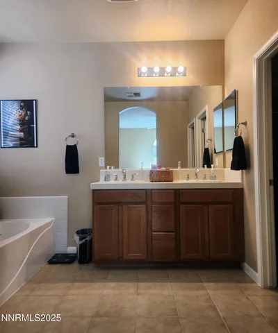 a kitchen with stainless steel appliances granite countertop a sink a stove a refrigerator a microwave oven with granite countertops and cabinets