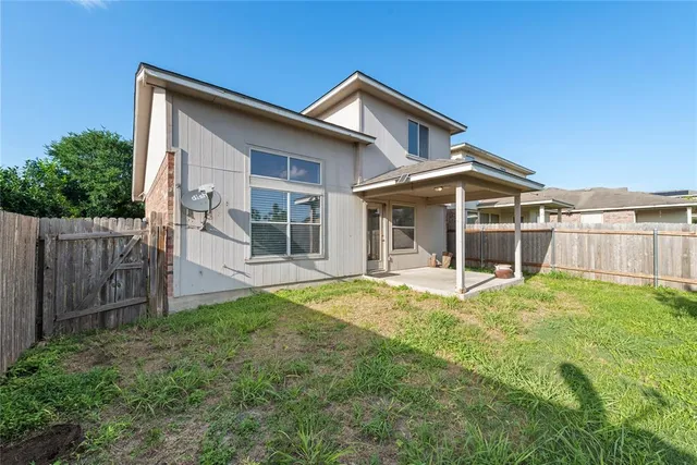 a view of a house with wooden fence