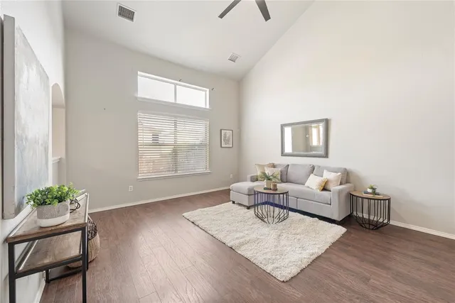 a living room with furniture and a wooden floor