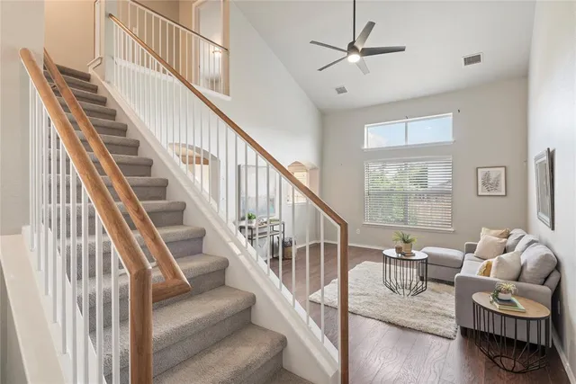 a living room with furniture and stairs
