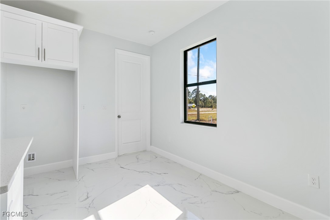 1152 Randolph Street Lehigh Acres, FL 33974 - Photo 18 of 50 an empty room with windows