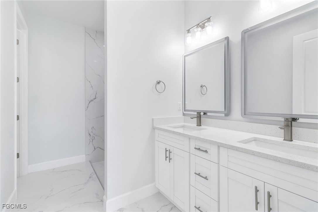 1152 Randolph Street Lehigh Acres, FL 33974 - Photo 19 of 50 a bathroom with a sink and a mirror