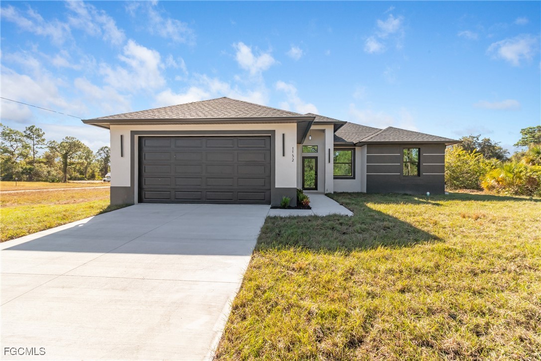 1152 Randolph Street Lehigh Acres, FL 33974 - Photo 2 of 50 a front view of a house with a yard