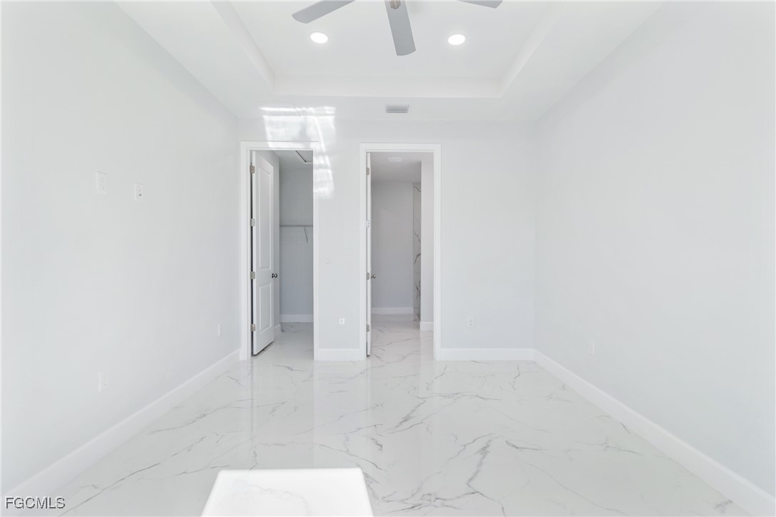 1152 Randolph Street Lehigh Acres, FL 33974 - Photo 23 of 50 an empty room with white walls and tiles