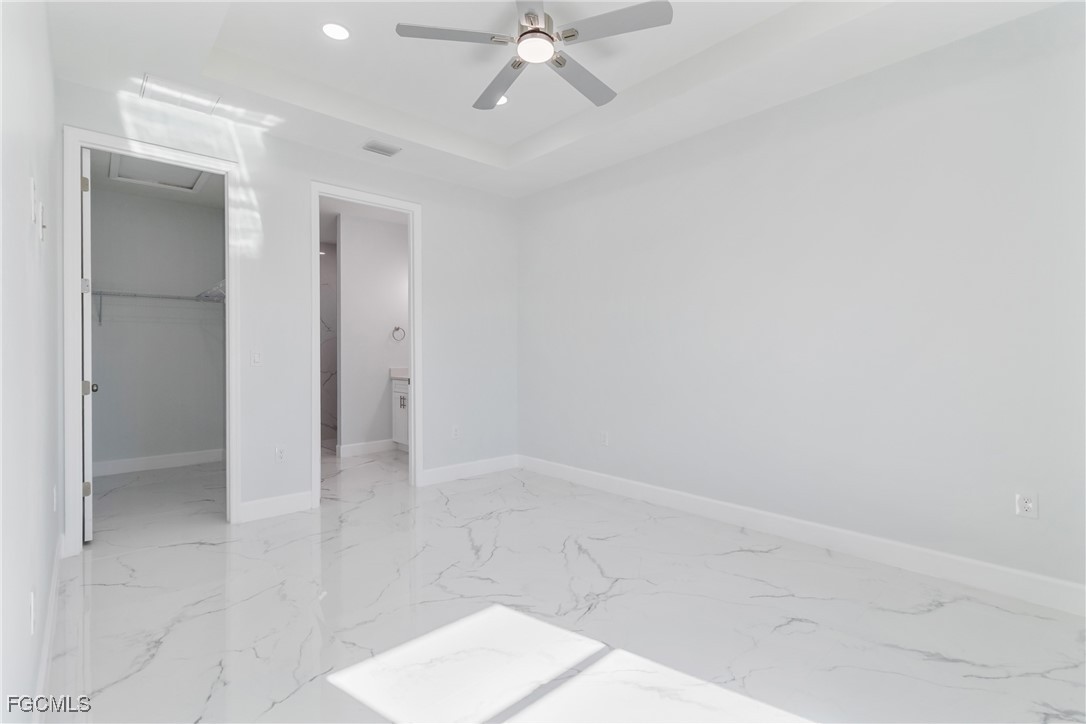 1152 Randolph Street Lehigh Acres, FL 33974 - Photo 25 of 50 an empty room with a ceiling fan and glass door