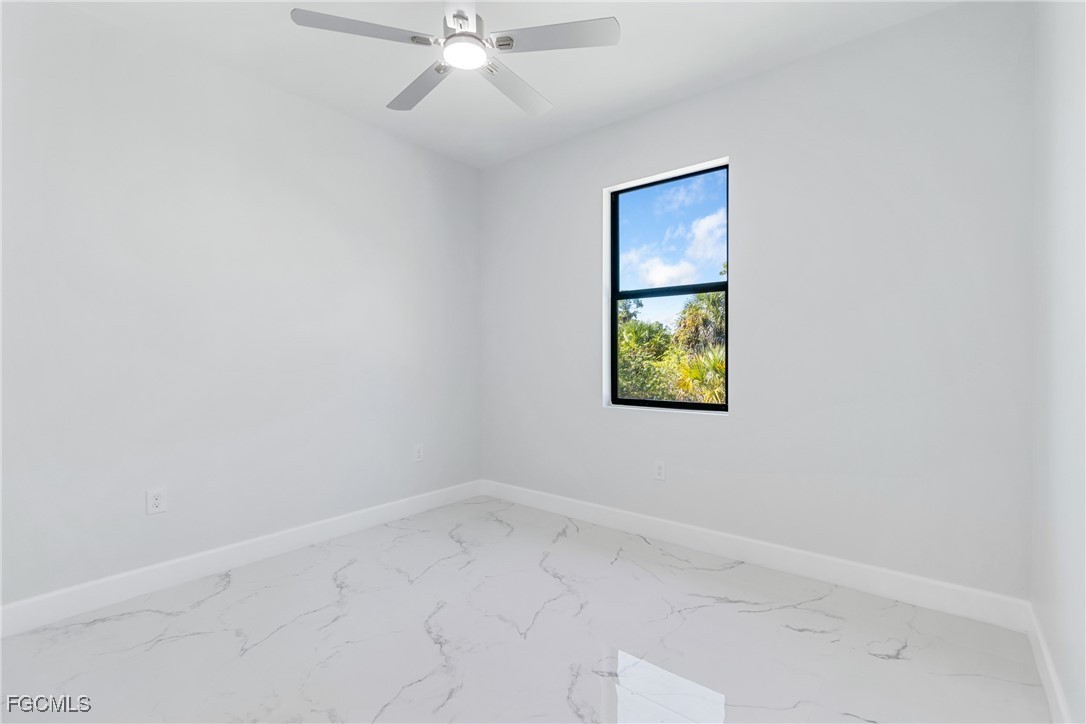 1152 Randolph Street Lehigh Acres, FL 33974 - Photo 28 of 50 an empty room with a window and a fan
