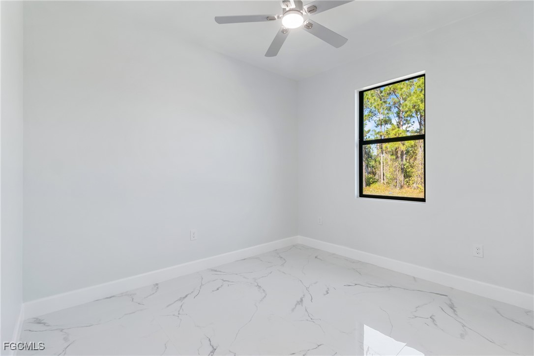 1152 Randolph Street Lehigh Acres, FL 33974 - Photo 30 of 50 an empty room with windows and fan