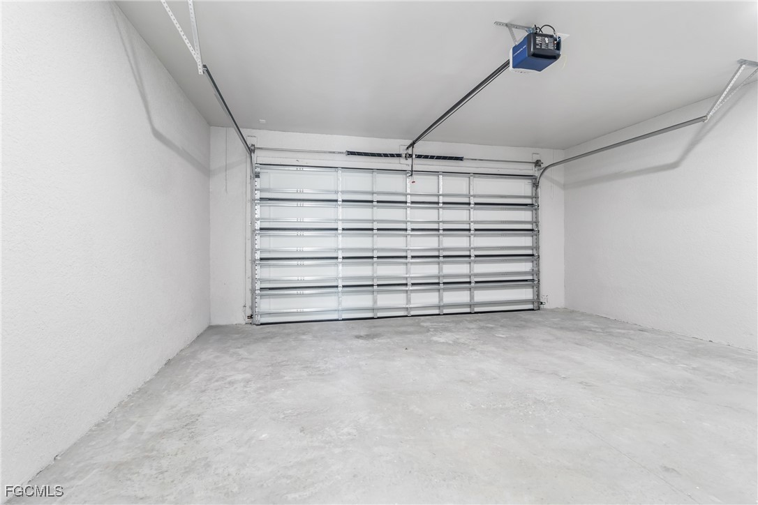 1152 Randolph Street Lehigh Acres, FL 33974 - Photo 33 of 50 a view of an empty room with a white car parked