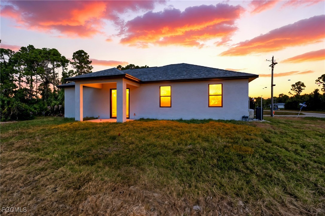 1152 Randolph Street Lehigh Acres, FL 33974 - Photo 36 of 50 a front view of a house with a yard