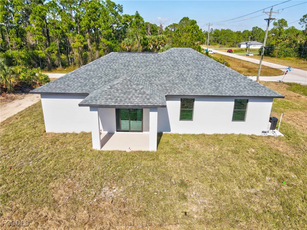 1152 Randolph Street Lehigh Acres, FL 33974 - Photo 40 of 50 a front view of a house with a yard and garage