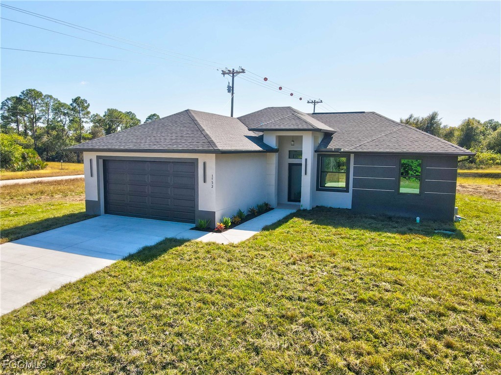 1152 Randolph Street Lehigh Acres, FL 33974 - Photo 42 of 50 a front view of a house with a yard