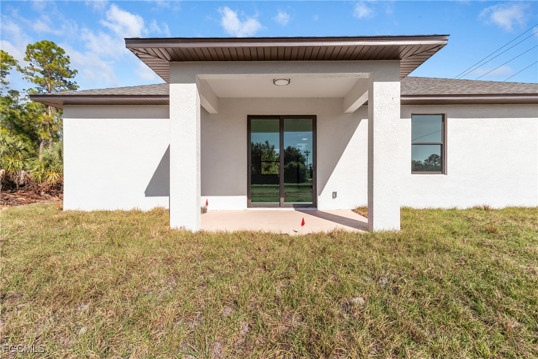 1152 Randolph Street Lehigh Acres, FL 33974 - Photo 45 of 50 a front view of a house with a yard