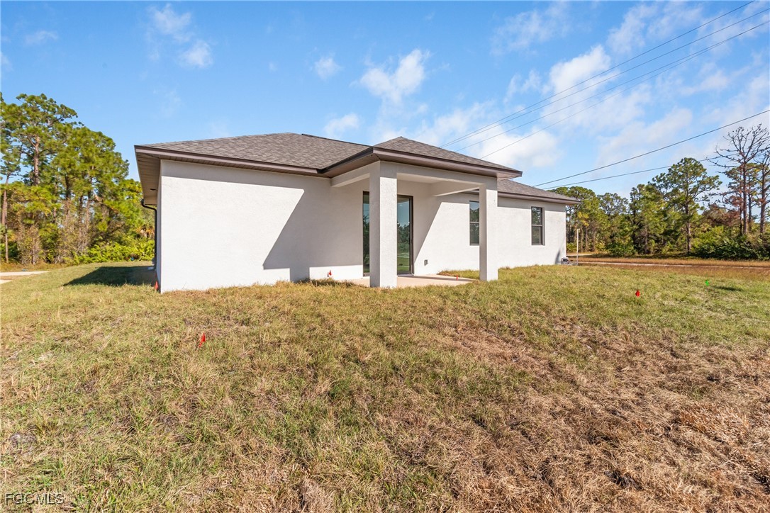 1152 Randolph Street Lehigh Acres, FL 33974 - Photo 46 of 50 a front view of a house with a yard