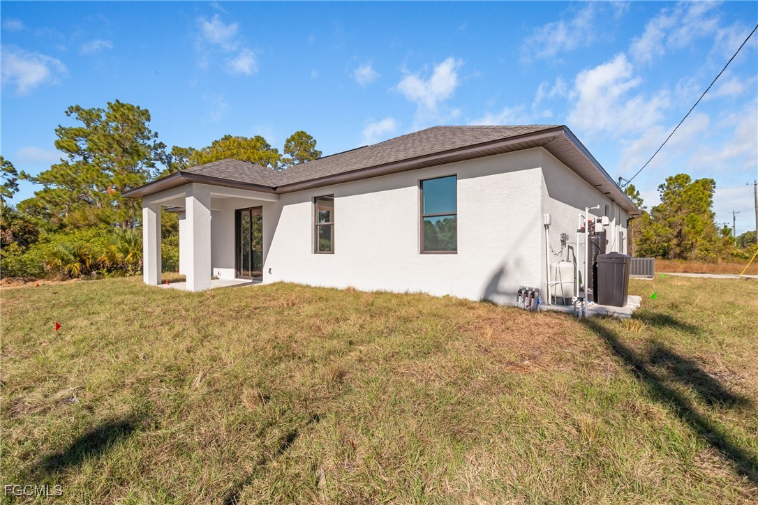 1152 Randolph Street Lehigh Acres, FL 33974 - Photo 47 of 50 a view of a house with a yard