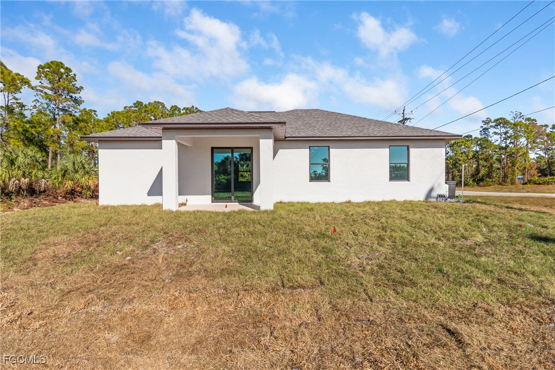 1152 Randolph Street Lehigh Acres, FL 33974 - Photo 48 of 50 a view of a house with a yard