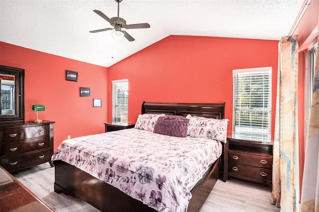 a bedroom with a bed and dresser with mirror