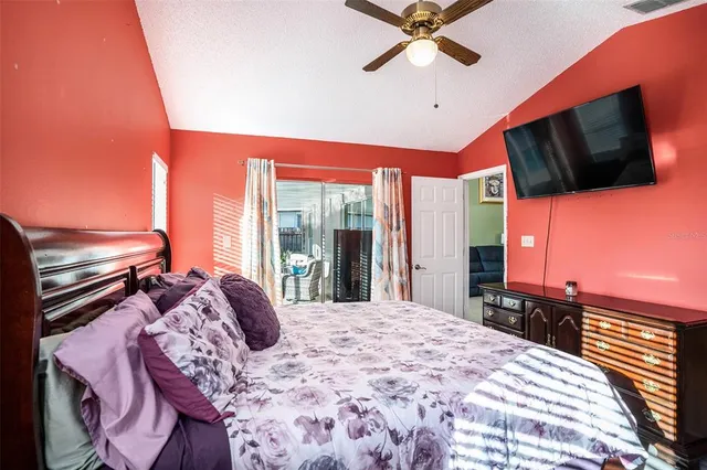 a bedroom with a bed and flat screen tv