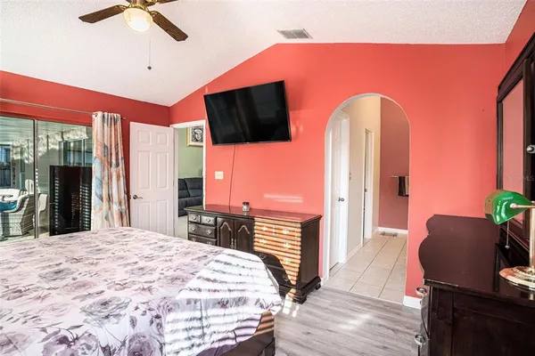 a bedroom with a bed and a flat screen tv