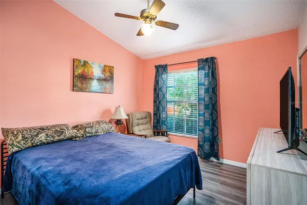 a bed sitting in a bedroom next to a window