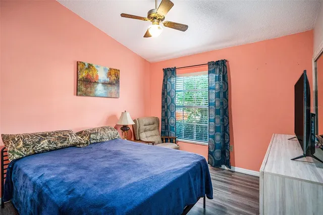 a bed sitting in a bedroom next to a window