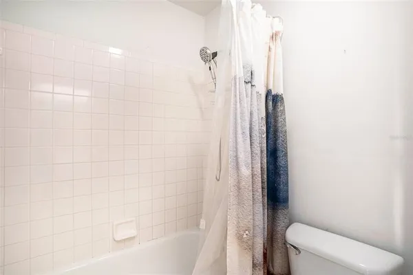 a bathroom with a shower and a toilet